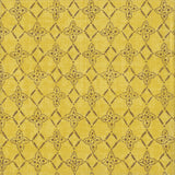 Detail of fabric in a botanical lattice print in brown on a mottled yellow field.