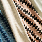 Gently draped fabric cuttings with a stacked linear diamond stripe in various colors.