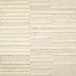 Broadloom carpet in a raised broken stripe pattern in cream on a cream field.