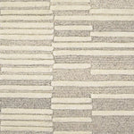 Broadloom carpet in a raised broken stripe pattern in cream on a grey field