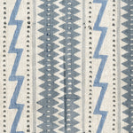 Fabric in a playful stripe and zigzag pattern in shades of gray and blue on a cream field.