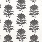 Detail of fabric in a repeating thistle print in gray on a white field.
