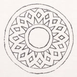 Detail of fabric in a repeating circular geometric print in gray on a white field.