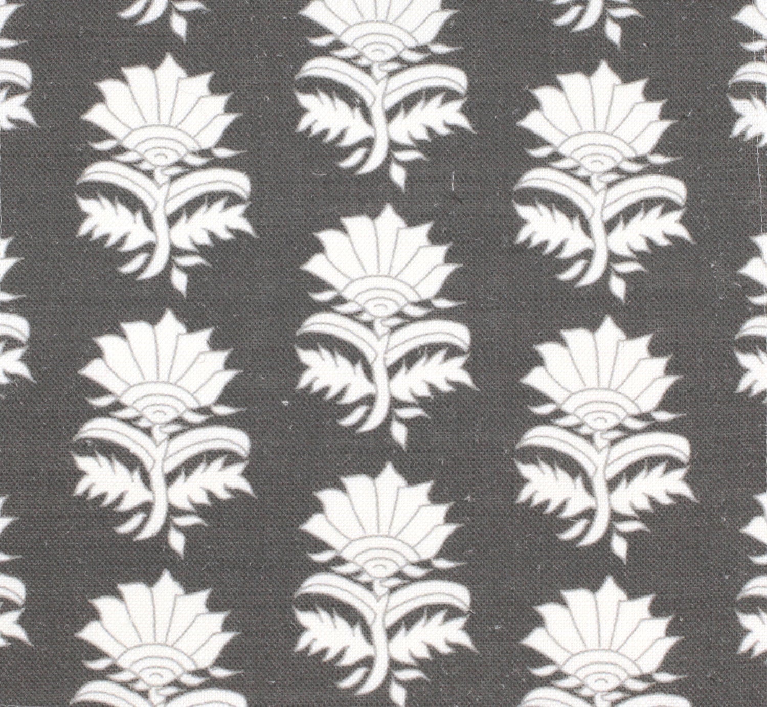 Detail of fabric in a repeating thistle print in white and gray on a charcoal field.