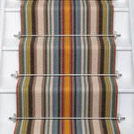 Striped flatweave runner in sage yellow red and blue on white staircase