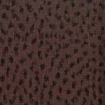 Fabric in a cheetah print in black on a brown field.
