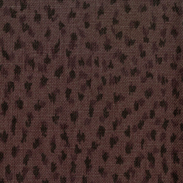 Fabric in a cheetah print in black on a brown field.