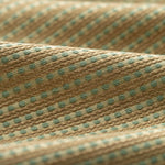 Lightly folded fabric with green dots and tan stripes on a white background