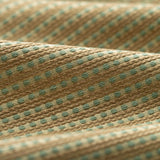 Lightly folded fabric with green dots and tan stripes on a white background