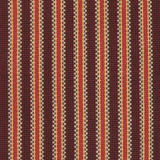 Detail of a hand-woven cotton striped fabric in shades of red, brown and yellow.