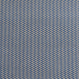 Detail of a hand-woven cotton fabric in a grid pattern in blue and tan.