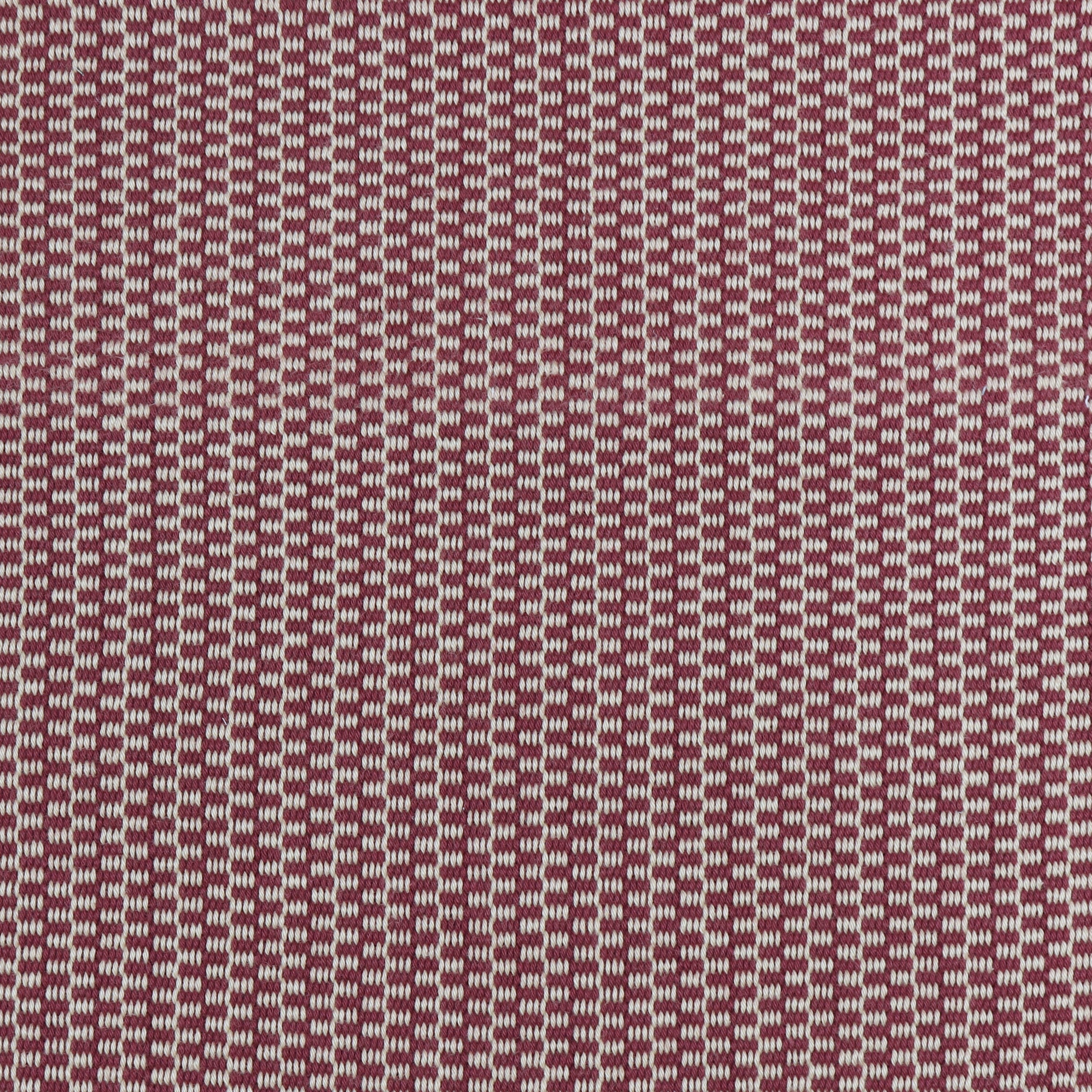 Detail of a hand-woven cotton fabric in a grid pattern in light gray and maroon.