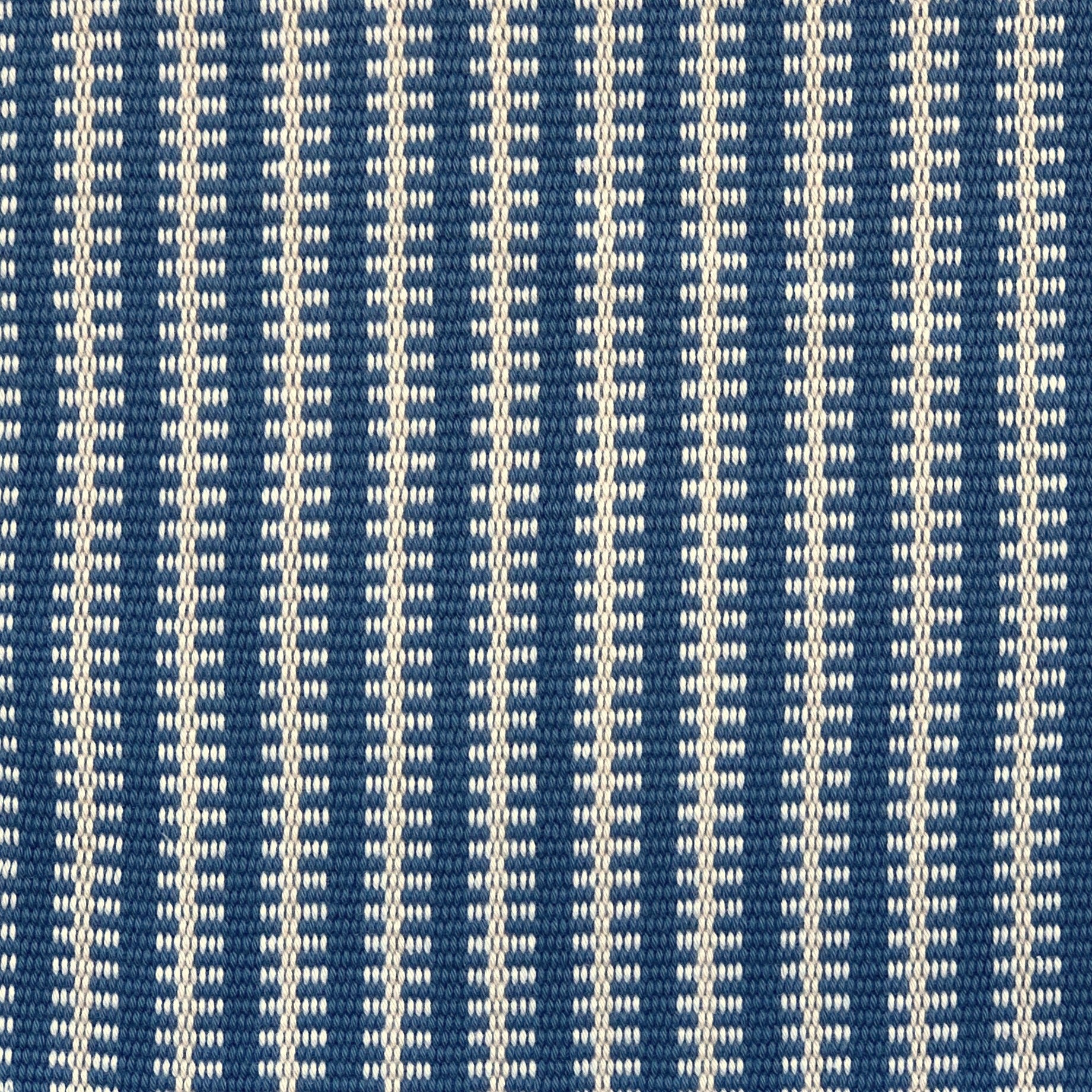 Detail of a hand-woven cotton fabric in an intricate gridded stripe pattern in shades of cream, blue and navy.