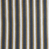Detail of a hand-woven cotton fabric in an intricate stripe pattern in shades of blue, brown, yellow and white.