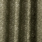 Draped linen fabric in a repeating chrysanthemum pattern in cream on an olive field.