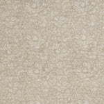 Detail of a printed linen fabric in a repeating chrysanthemum pattern in white on a cream field.