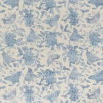 Printed linen fabric in a repeating flower and butterfly pattern in misty blue on a cream field.