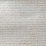 Broadloom carpet in a lightly ribbed cut pile in cool white. 