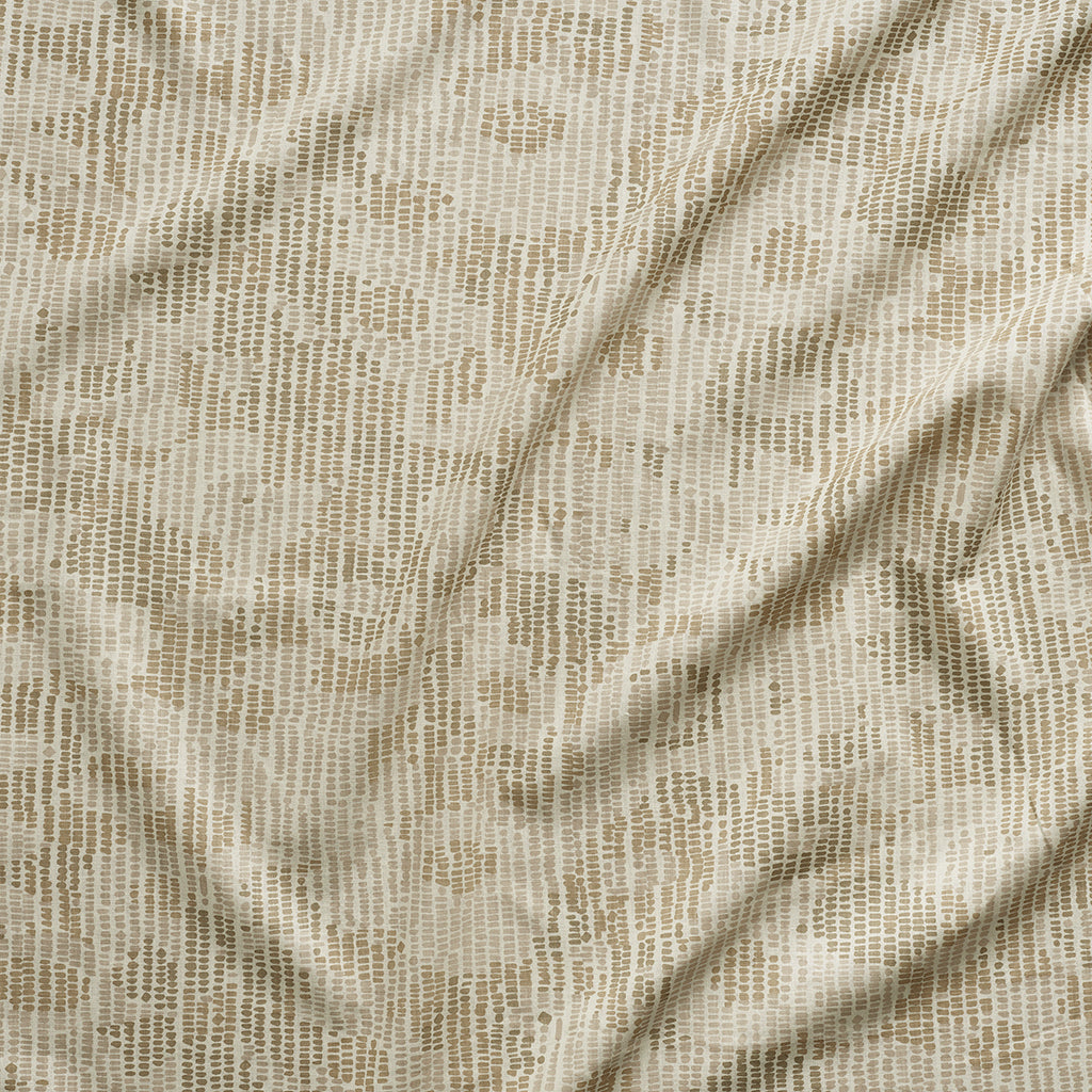 A close up of gently draped printed fabric with a pointillist abstract floral pattern in beige and taupe on white. 