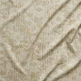 A close up of gently draped printed fabric with a pointillist abstract floral pattern in beige and taupe on white. 
