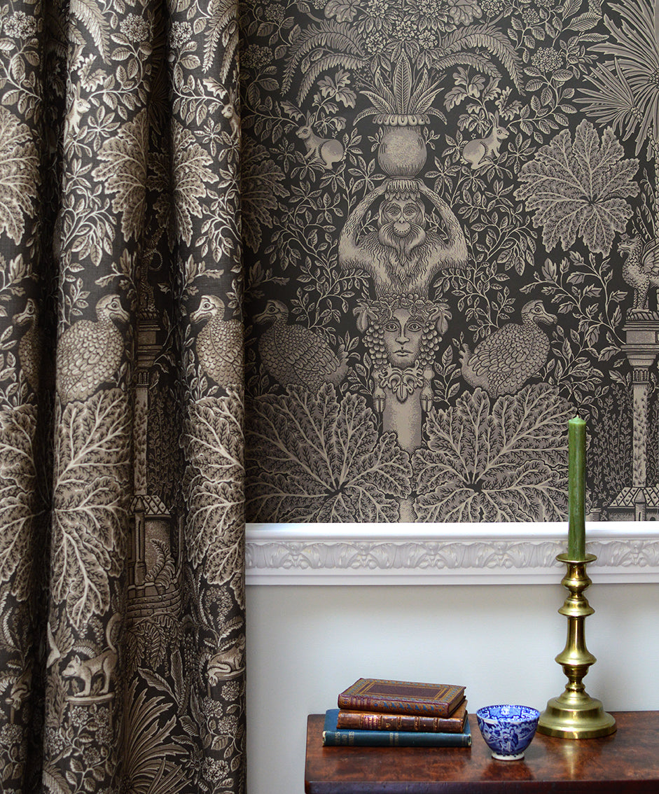 Decorative curtain with intricate patterns and a candlestick holder on a table.