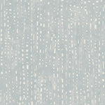 Detail of wallpaper in a painterly small-scale dashed dot print in white on a pale blue watercolor field.