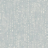 Detail of wallpaper in a painterly small-scale dashed dot print in white on a pale blue watercolor field.