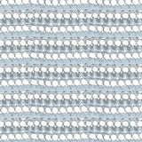 Detail of fabric in a dense curvilinear stripe print in cream, blue and gray.