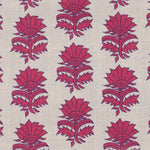 Detail of fabric in a repeating thistle print in pink and purple on a tan field.