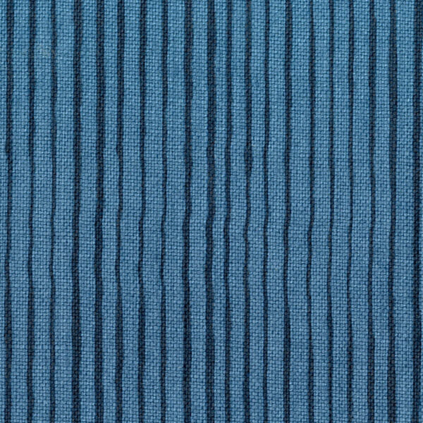Fabric in a painterly stripe pattern in navy on a blue field.