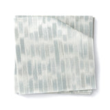 Stacked swatches of fabric in a linear check pattern in shades of pastel aqua blue on a white background