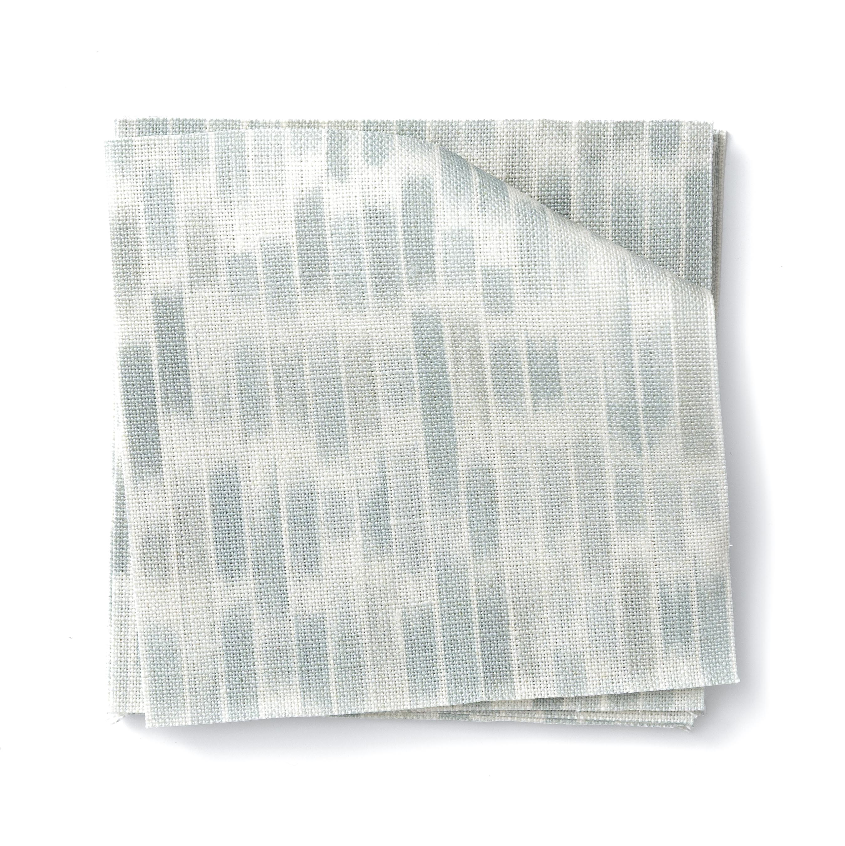 Stacked swatches of fabric in a linear check pattern in shades of pastel aqua blue on a white background