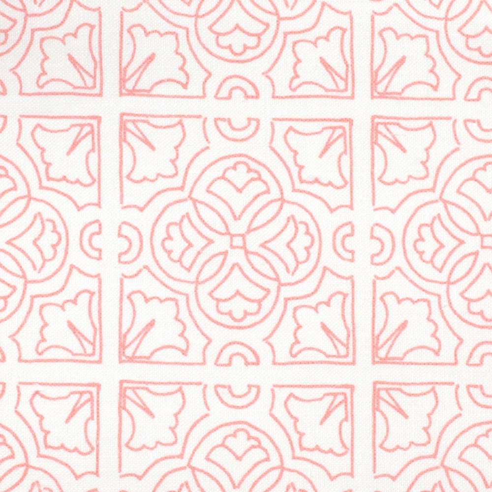 Detail of fabric in a damask lattice print in pink on a white field.