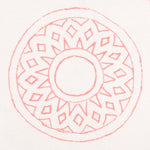 Detail of fabric in a repeating circular geometric print in pink on a white field.