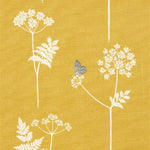 Detail of fabric in a playful flower and butterfly print in white and charcoal on a mustard field.