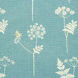 Detail of fabric in a playful flower and butterfly print in cream and tan on a blue field.