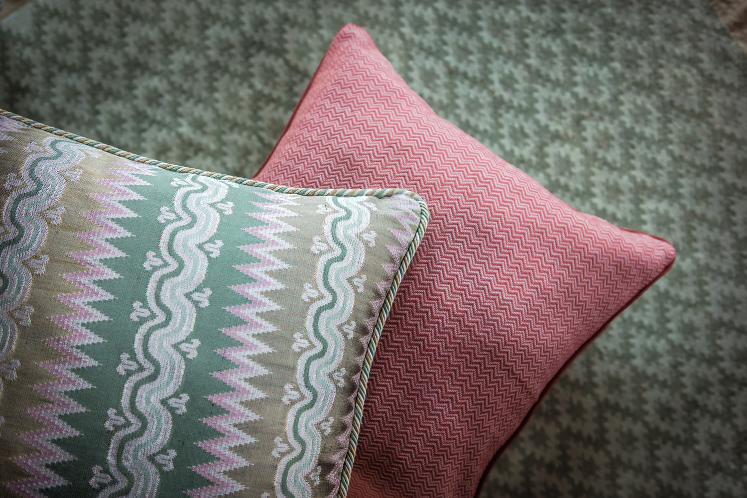 Two patterned cushions on a textured surface