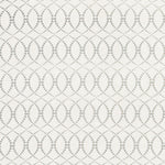 Detail of fabric in a playful floral lattice print in yellow and navy on a cream field.