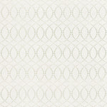 Detail of fabric in a playful floral lattice print in orange and turquoise on a cream field.
