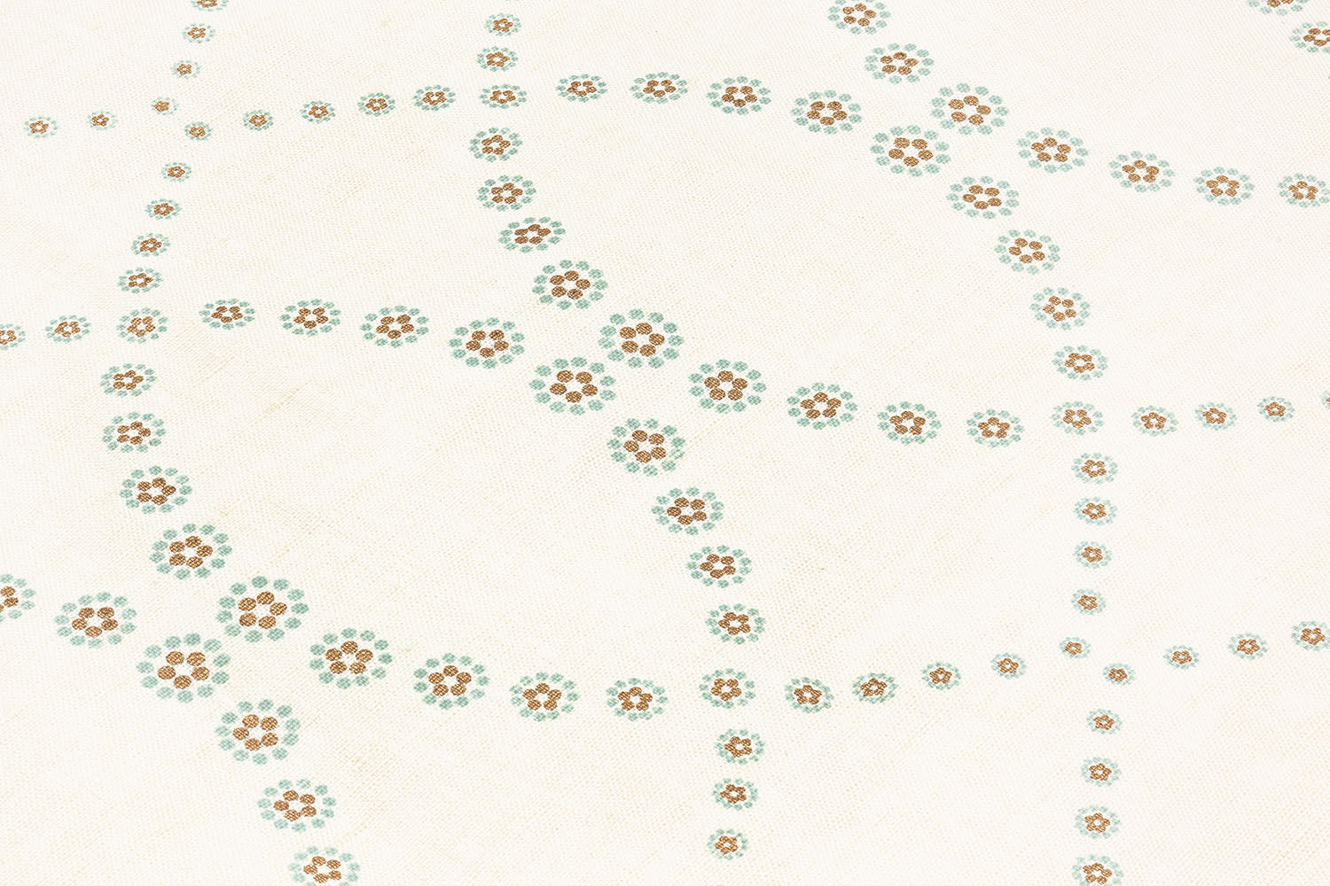 Fabric yardage in a playful floral lattice print in orange and turquoise on a cream field.