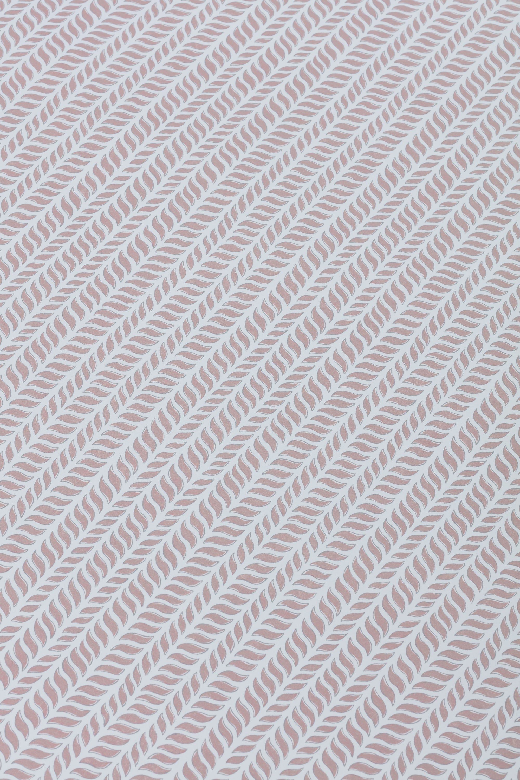 Detail of a wallpaper panel in a painterly herringbone print in mauve on a light blue field.