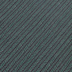 Detail of a wallpaper panel in a painterly herringbone print in green and light blue on a navy field.