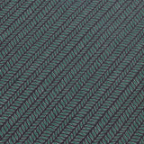 Detail of a wallpaper panel in a painterly herringbone print in green and light blue on a navy field.