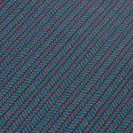 Detail of a wallpaper panel in a painterly herringbone print in turquoise and pink on a navy field.