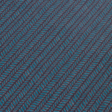 Detail of a wallpaper panel in a painterly herringbone print in turquoise and pink on a navy field.