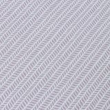Detail of a wallpaper panel in a painterly herringbone print in purple on a light blue field.