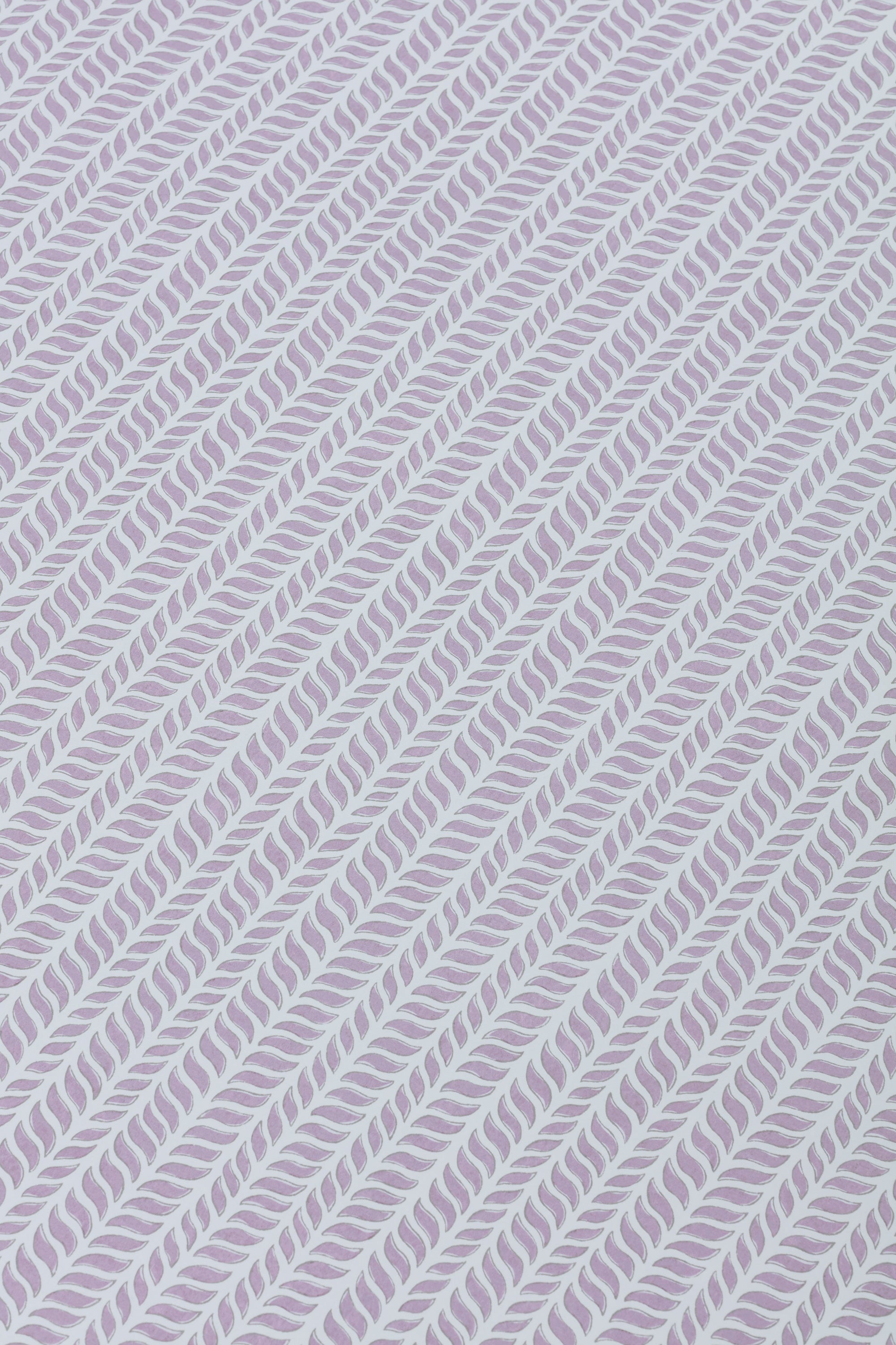 Detail of a wallpaper panel in a painterly herringbone print in purple on a light blue field.