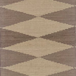 Geometric patterned rug with diamond shapes in brown and beige tones
