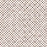 Detail of fabric in a painterly grid pattern in brown on a white field.