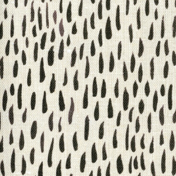 Fabric in a painterly dabbed print in charcoal on a cream field.